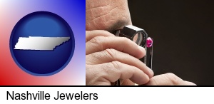 Nashville, Tennessee - a jeweler examining a jewel