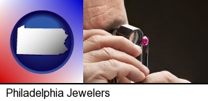 Philadelphia, Pennsylvania - a jeweler examining a jewel