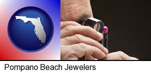 a jeweler examining a jewel in Pompano Beach, FL