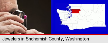 a jeweler examining a jewel; Snohomish County highlighted in red on a map
